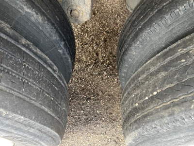 Hopper trailer tires and gravel ground view for 2008 Cornhusker Air Ride Grain Hopper showcasing dual tires