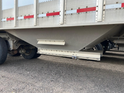 Cornhusker air ride grain hopper trailer side view showing undercarriage and support legs