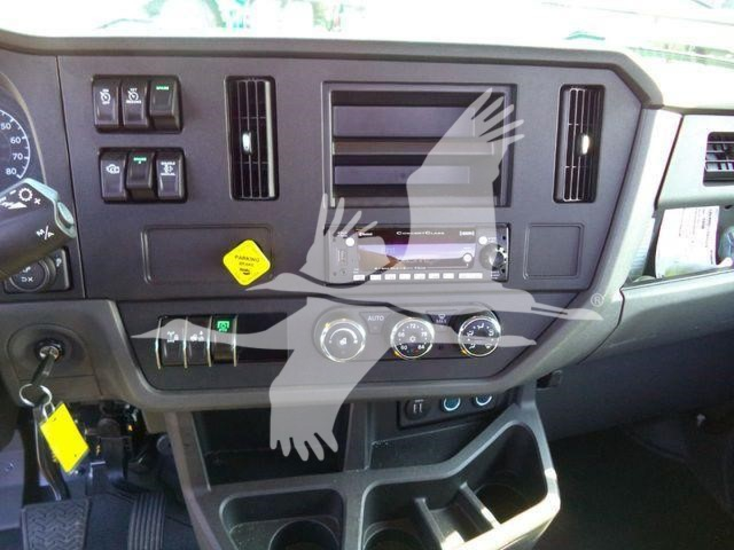 Truck dashboard of a 2026 Peterbilt 536 with controls, vents, and media/navigation screen visible.