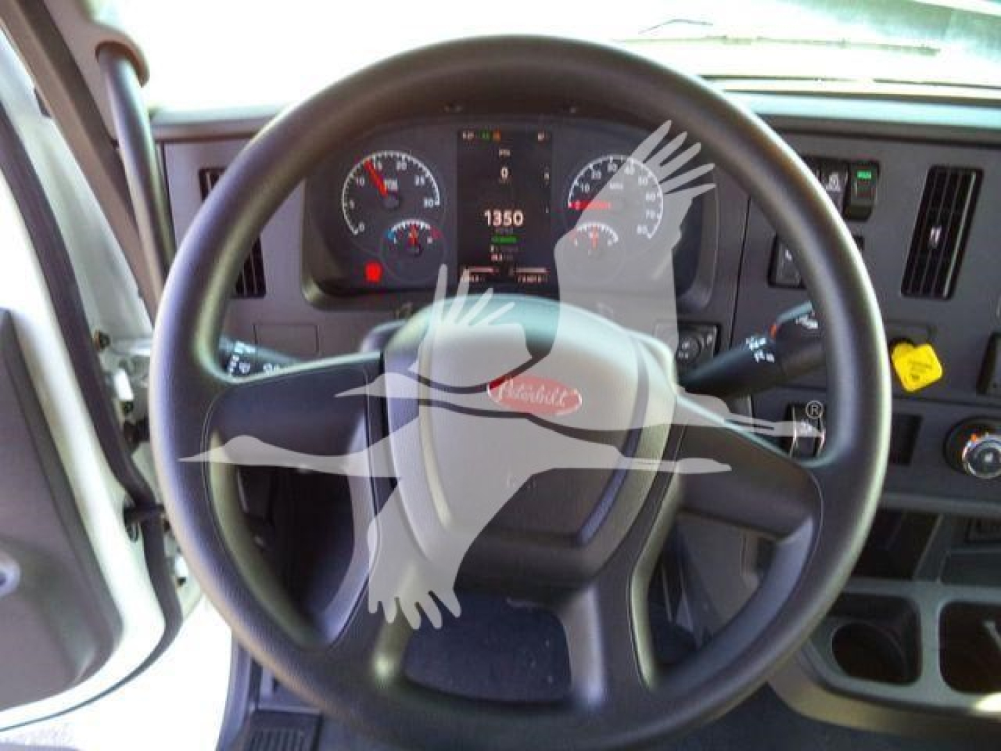 Peterbilt 536 truck dashboard and steering wheel view showing gauges and controls.