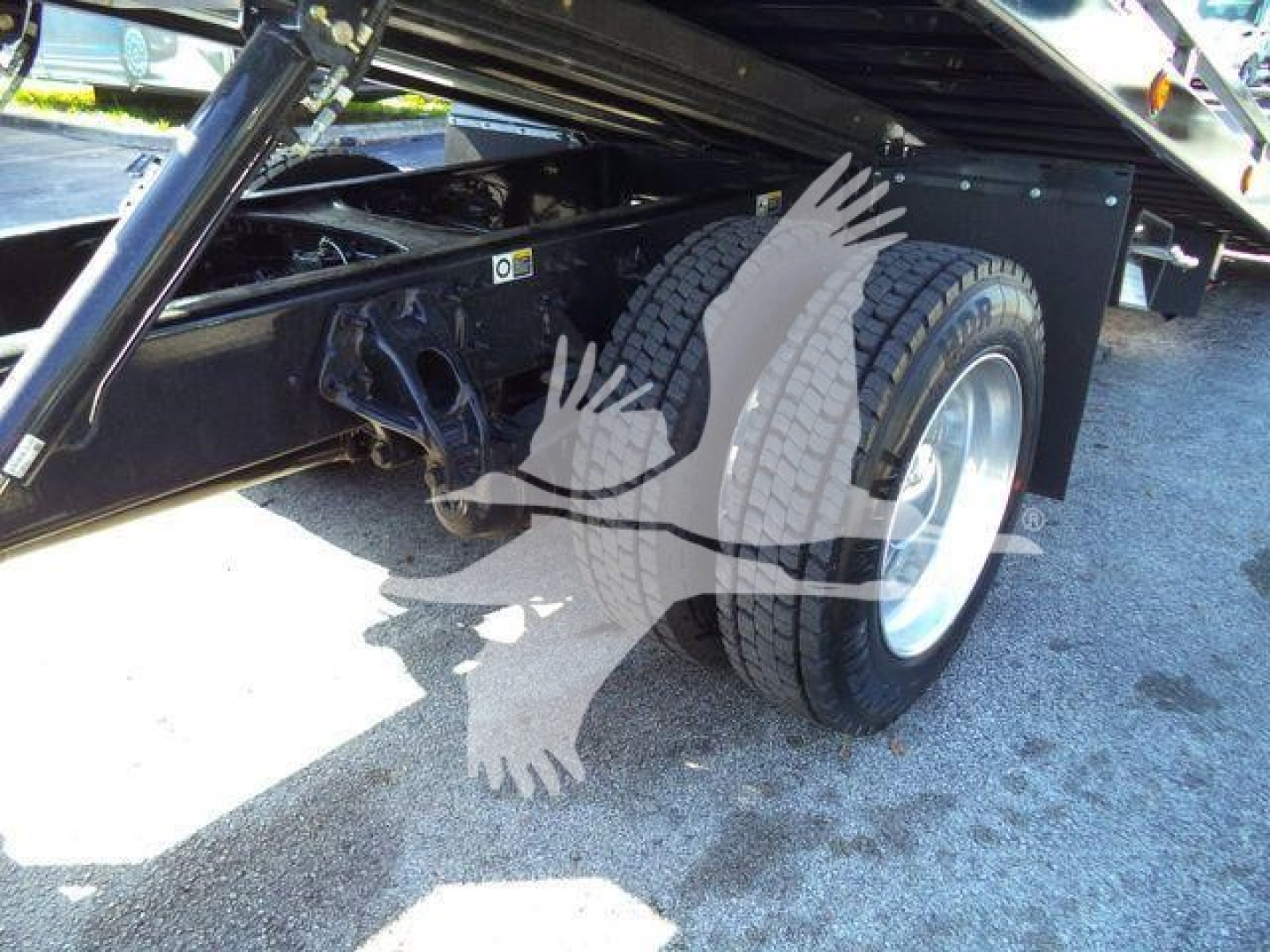 Peterbilt 536 rollback truck rear wheel area showing dual rear tires and undercarriage frame with suspension components.