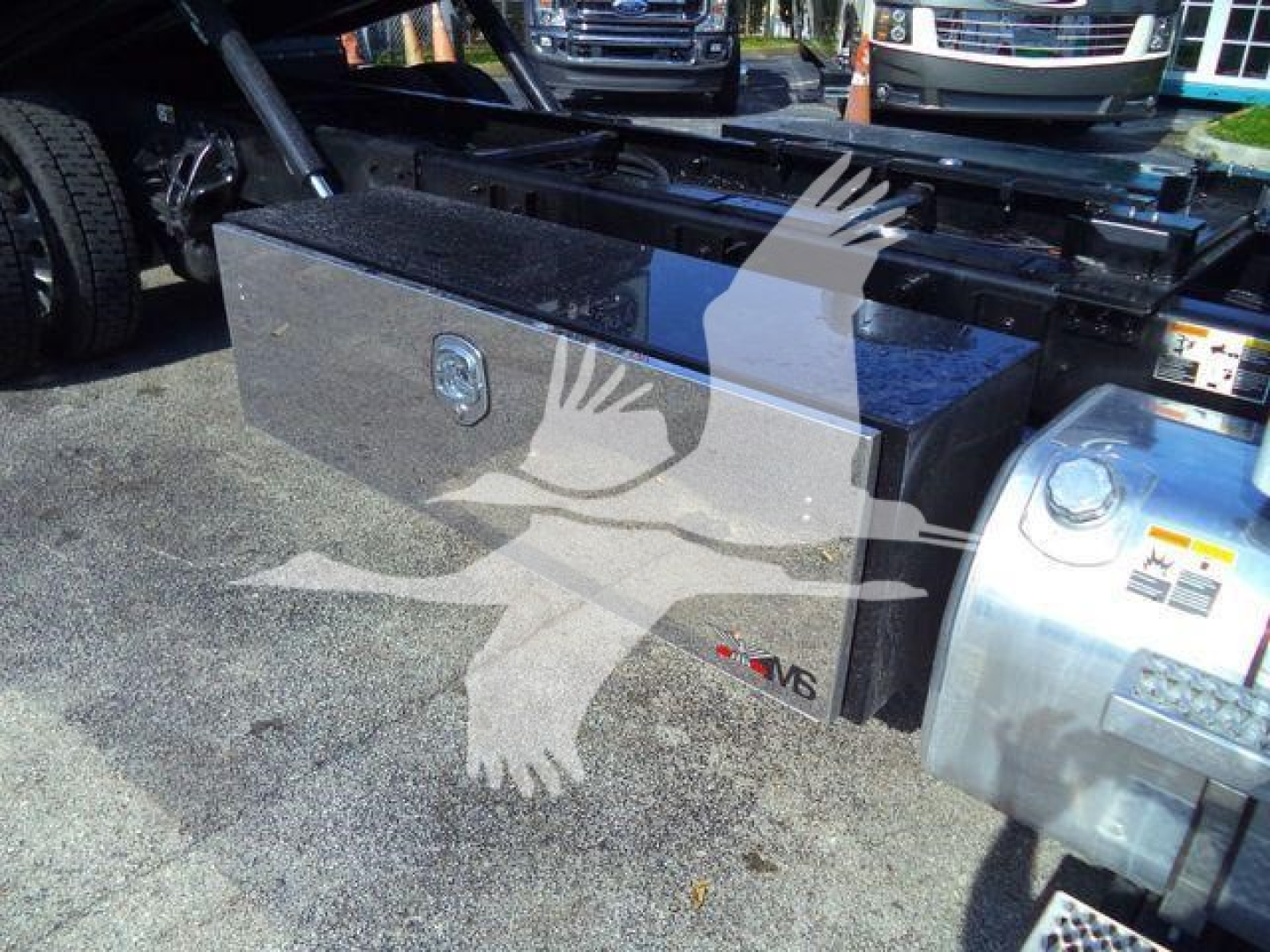 Peterbilt 536 rollback truck fuel/toolbox area showing a large rectangular aluminum toolbox mounted behind the cab, with a lock and N8 badge on the toolbox.