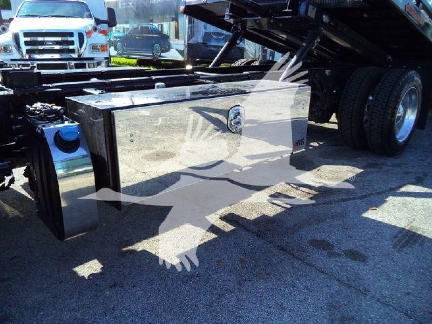 Peterbilt 536 rollback truck undercarriage showing rectangular metal tool/storage box and rear wheels.