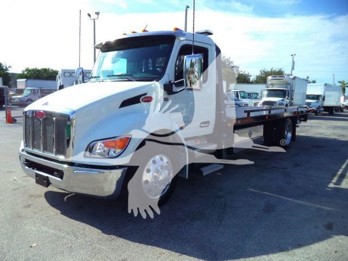 Peterbilt 536 rollback truck in white, front-left view showing cab, chrome grille, headlights, and flatbed chassis.