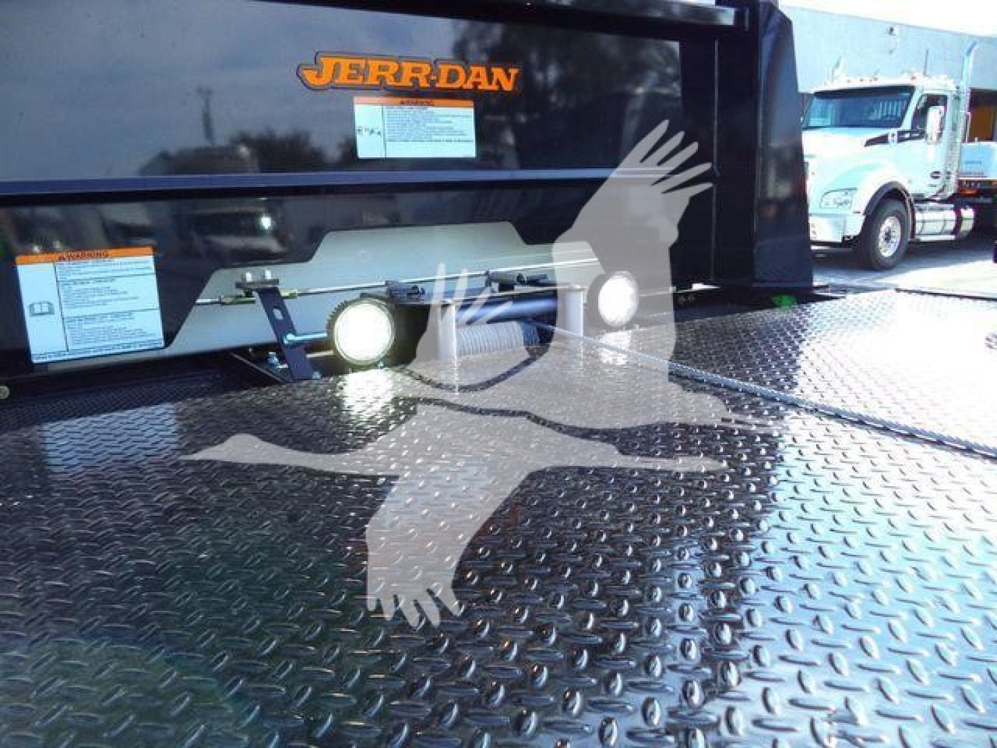 Peterbilt 536 rollback truck rear view showing Jerr-Dan branding, winches, and diamond plate deck.