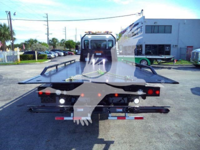 Tow truck flatbed with a Peterbilt 536 rollback bed viewed from rear. Stock number 1PETE536XLP22, new, in a dealership lot.
