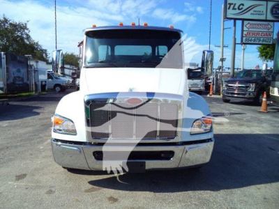 Peterbilt 536 rollback truck front view showing large chrome grille, headlights, and bumper.