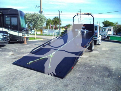 Peterbilt 536 rollback tow truck flatbed with loading ramp and rear winch.