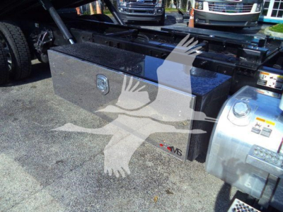 Peterbilt 536 rollback truck fuel/toolbox area showing a large rectangular aluminum toolbox mounted behind the cab, with a lock and N8 badge on the toolbox.