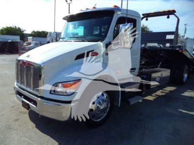 Peterbilt 536 rollback truck showing white cab and flatbed chassis, front grille, headlights, and side steps.