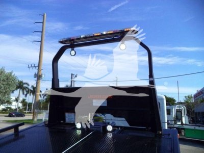 Peterbilt 536 rollback truck rear view showing overhead engine hoist and platform with lighting bar and brand decals.