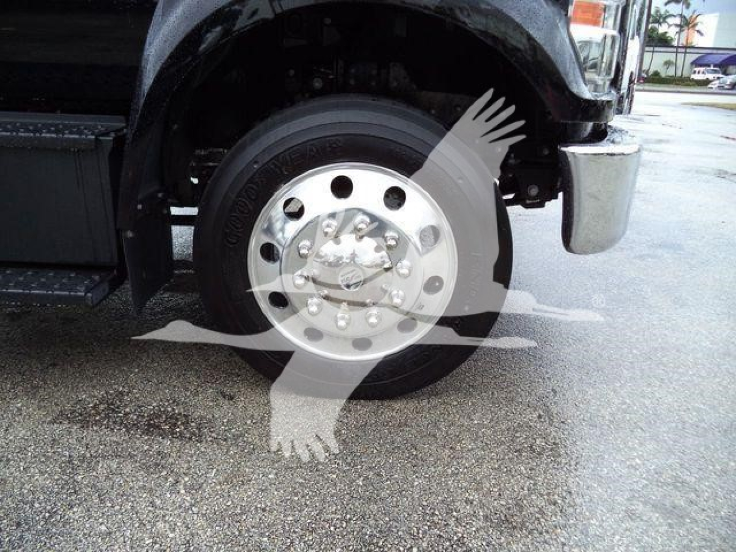 Ford F-750 SD wheel and front fender showing front tire and chrome hub with lug nuts.