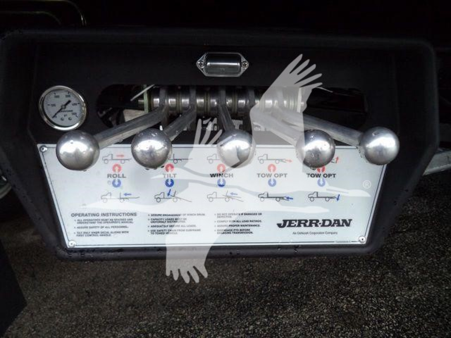 Dashboard-style control panel with six silver levers and a gauge on the left; labeled ‘JERR-DAN’ and operating instructions visible.