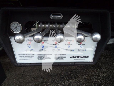 Dashboard-style control panel with six silver levers and a gauge on the left; labeled ‘JERR-DAN’ and operating instructions visible.