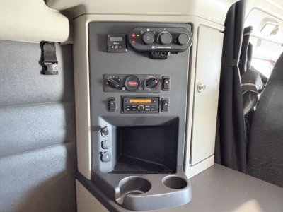 Peterbilt 579 cab interior center console panel showing climate controls, radio, and cup holders.