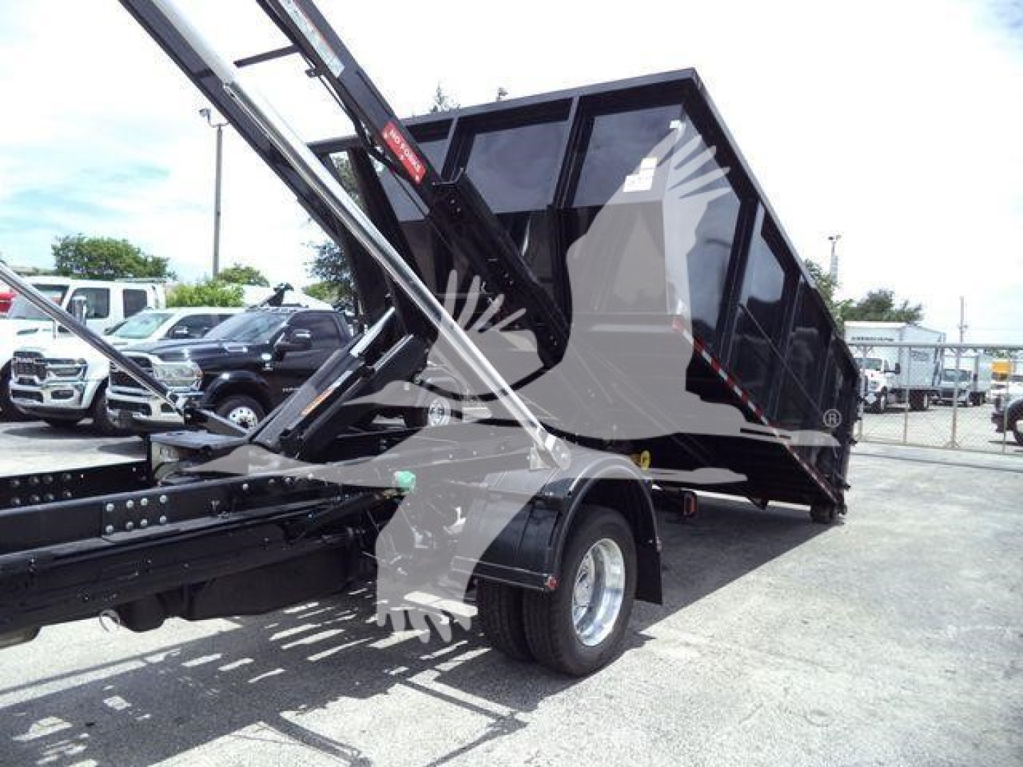 Ram 5500 dump truck in upright loading position showing side view and rear wheel