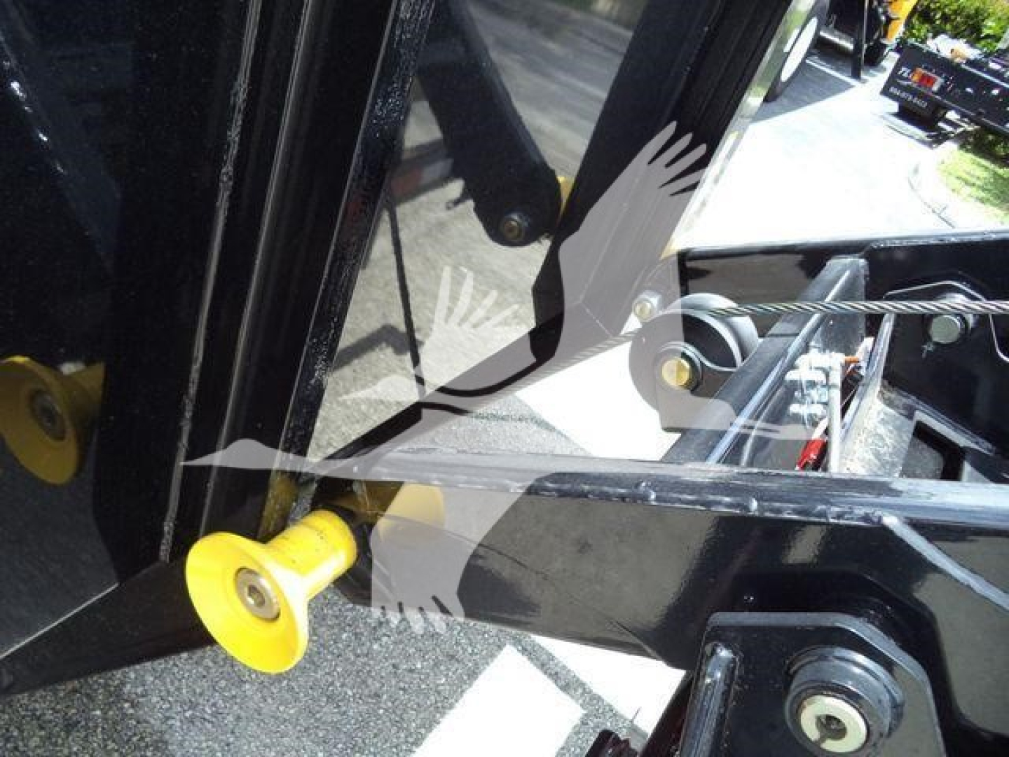 Ram 5500 roll-off truck hitch/frame with yellow hitch pin and black metal structure