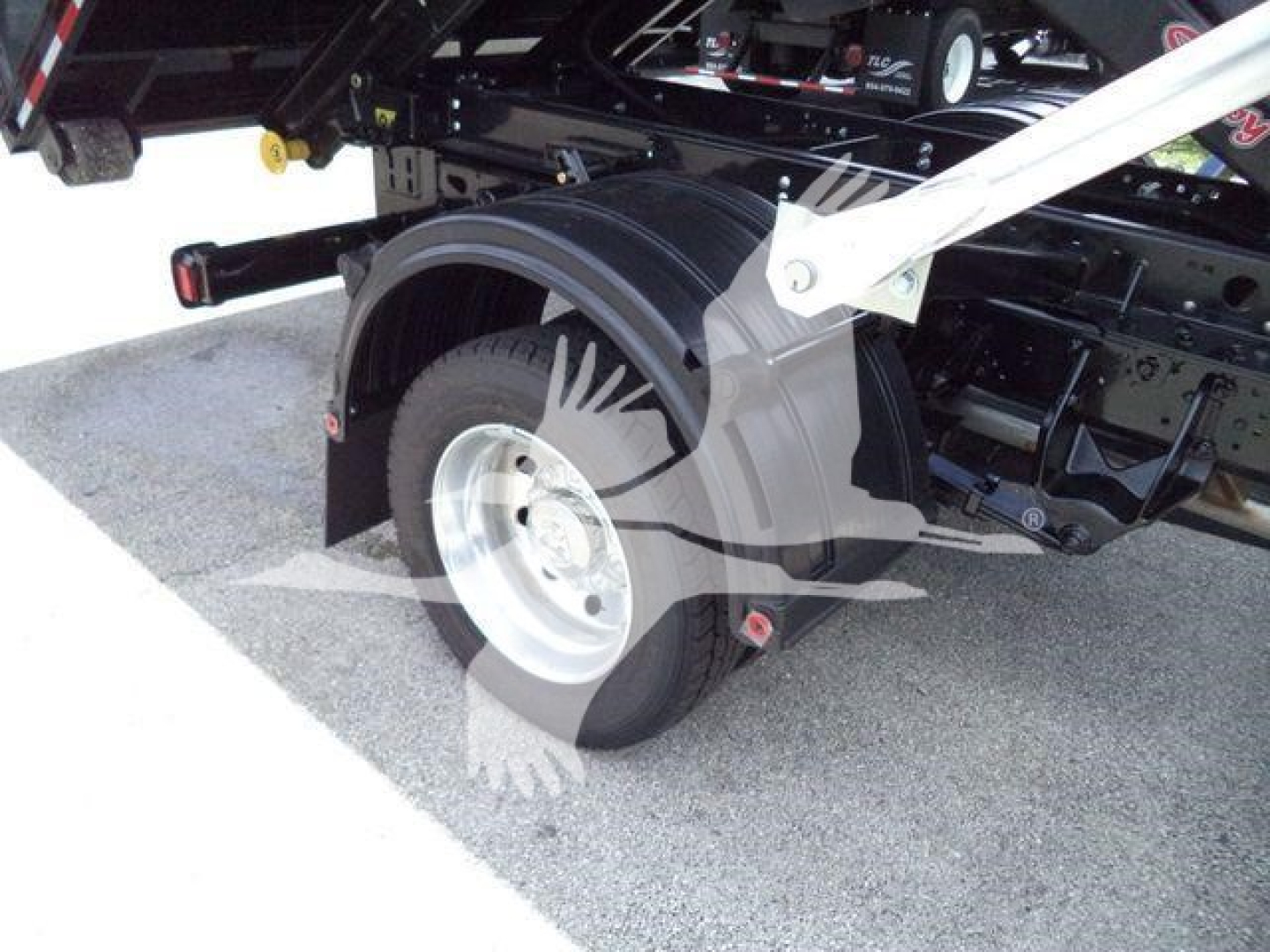 Ram 5500 rolloff truck rear wheel and fender, assembly in view with black chassis and silver rim