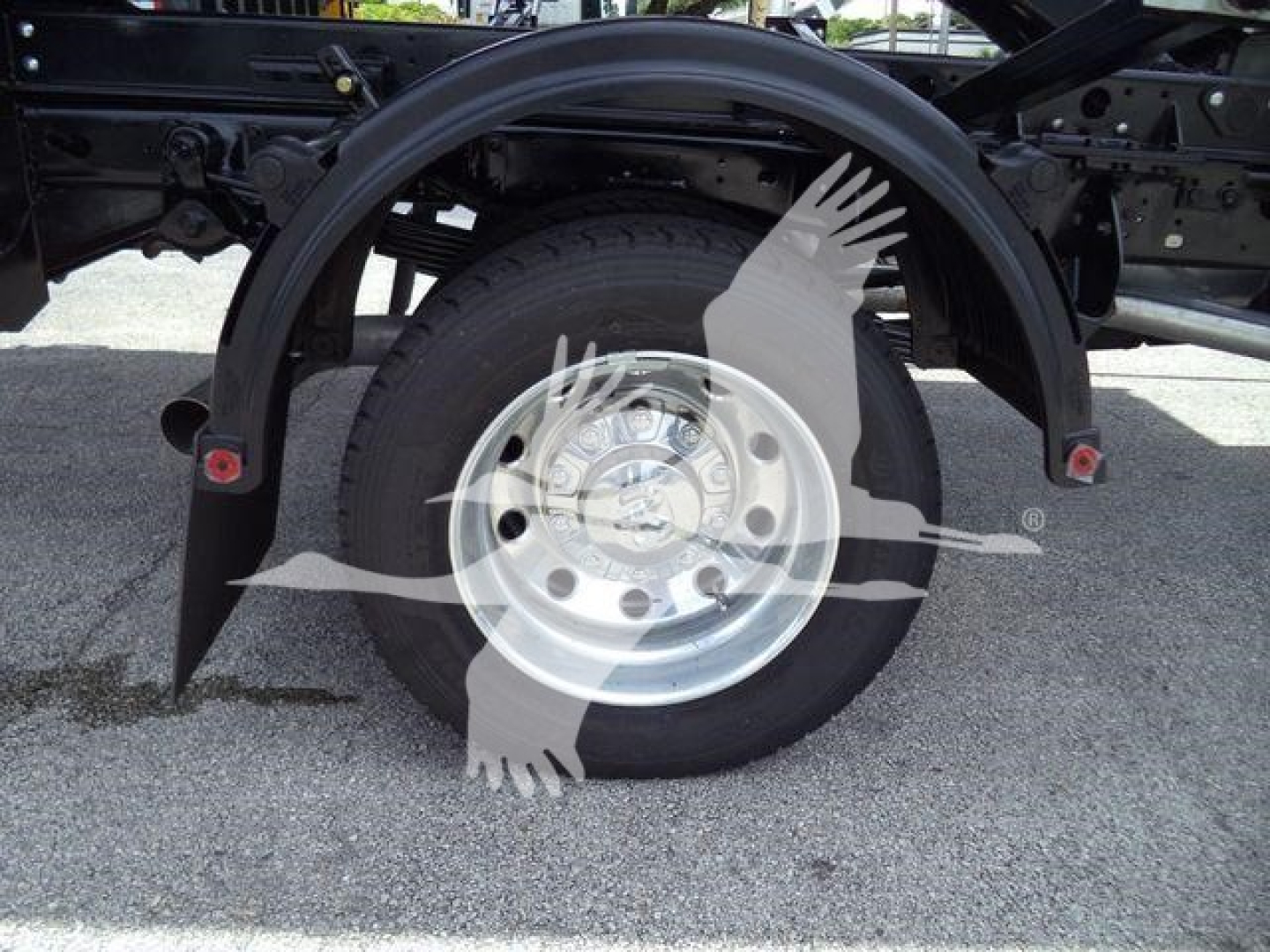Ram 5500 wheel and fender on a roll-off truck showing steel wheel, tire, and rear wheel arch.