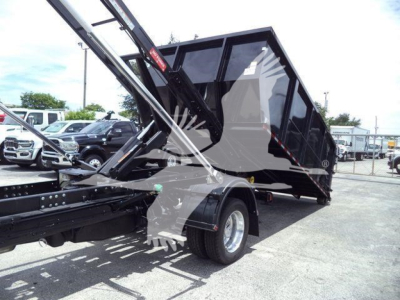 Ram 5500 dump truck in upright loading position showing side view and rear wheel
