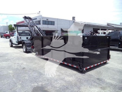 Ram 5500 rear view showing a large black dump or roll-off container attached to a truck, with a white cab in background.