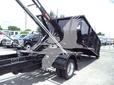 Ram 5500 SLT roll-off truck bed with hydraulic lifting arms and rear wheels visible.
