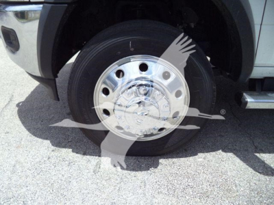 Ram 5500 SLT wheel assembly showing chrome steel hubcap and tire in front left fender well.