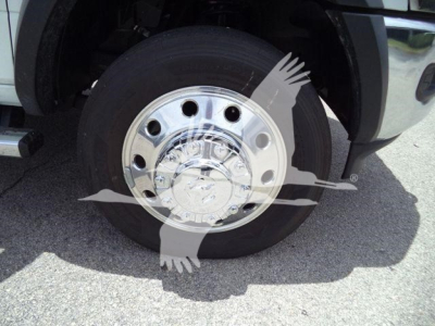Truck wheel close-up showing chrome polished hubcap and tire on Ram 5500 pickup.