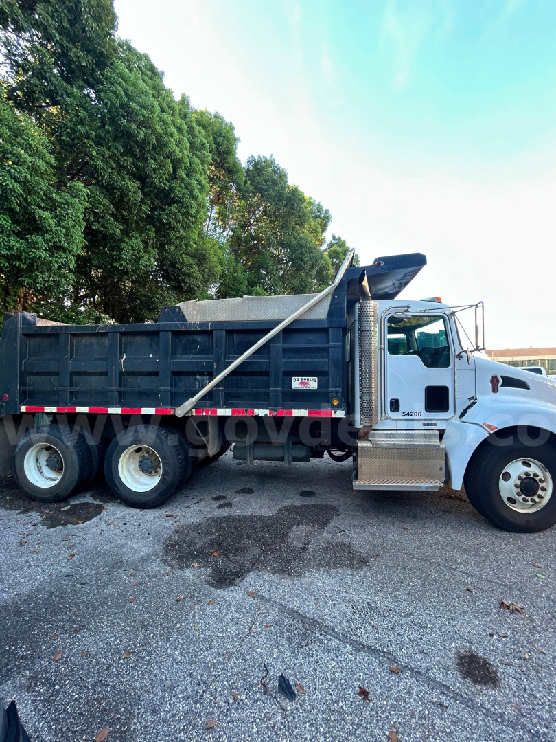 Kenworth T370 dump truck side view showing dump bed and cab with wheelbase, stock number 176-6671.