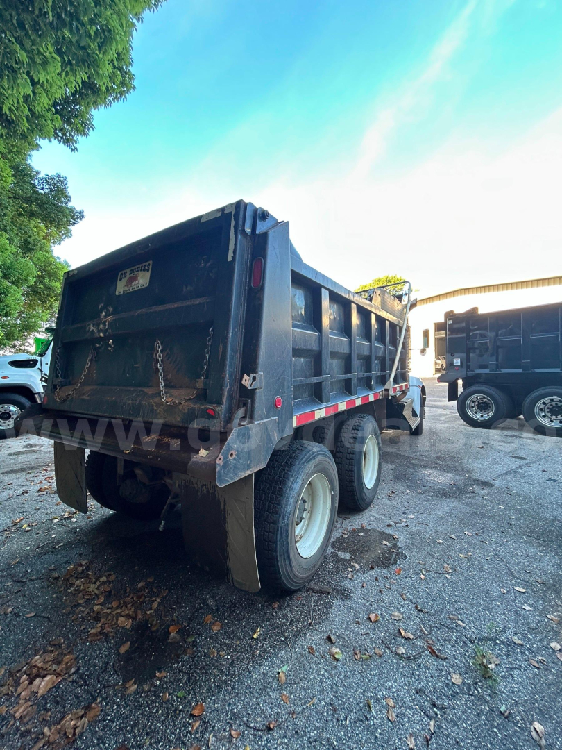 Dump truck bed showing rear view of Kenworth T370 dump truck with dual rear wheels and mud flaps.