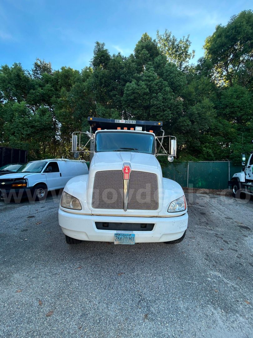 Front view of a Kenworth T370 dump truck showing large grille, hood ornament, headlights, and front bumper.
