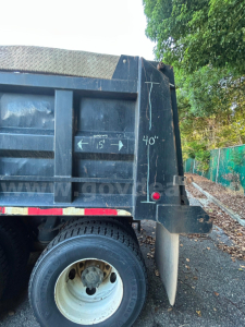 Kenworth dump truck side showing measurement markings on bed and rear tailgate with 40" height and 15" inner clearance.