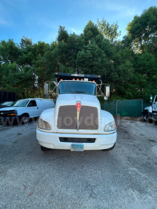 Front view of a Kenworth T370 dump truck showing large grille, hood ornament, headlights, and front bumper.