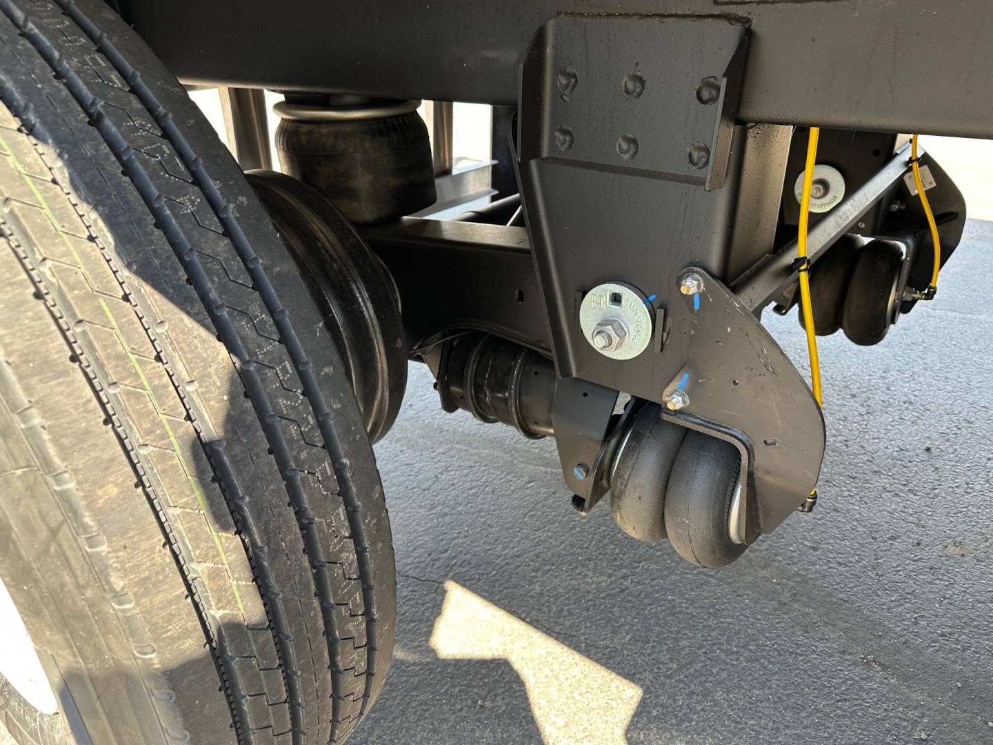 Trailer wheel assembly and landing gear showing heavy-duty caster and support components on a Timpte hopper trailer.