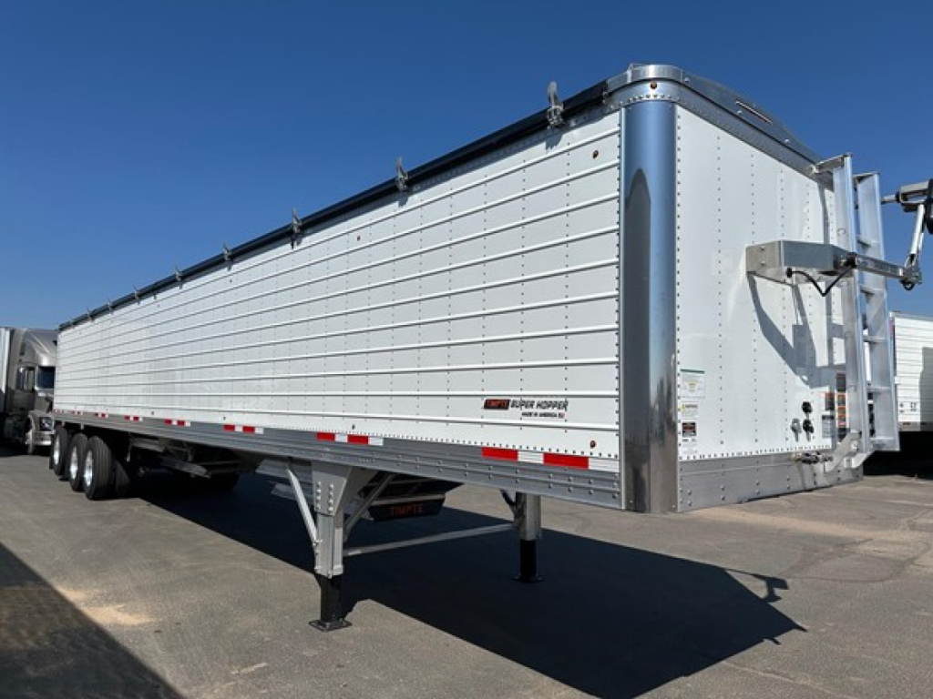 Timpte Super Hopper trailer showing side and front, aluminum panel sides, dual-axle rear, and front landing gear.