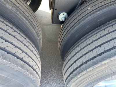 Trailer wheel twin-axle near-fork view showing dual tires and hub with grease cap, part of a Timpte hopper trailer