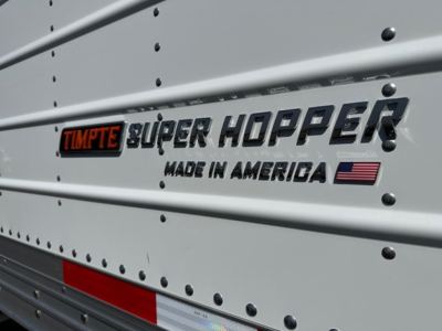 Timpte Super Hopper trailer side with embossed logo and Made in America text, riveted metal panels, U.S. flag graphic.