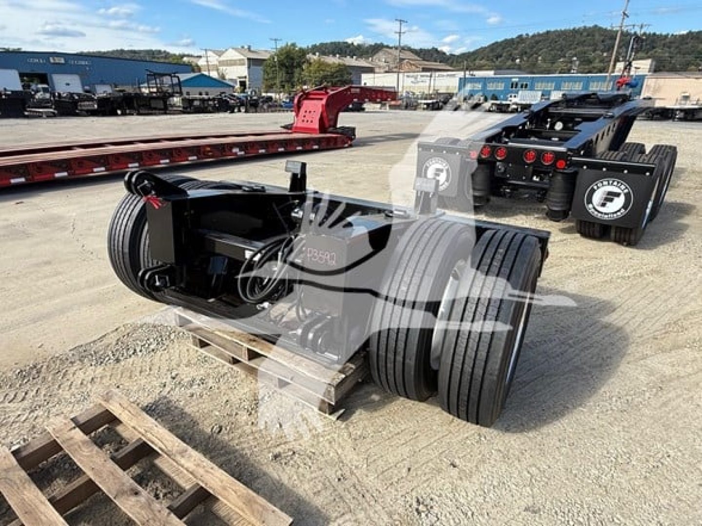 Fontaine flip axle trailer component showing large dual tires and hitch assembly with numerical label on metal frame.