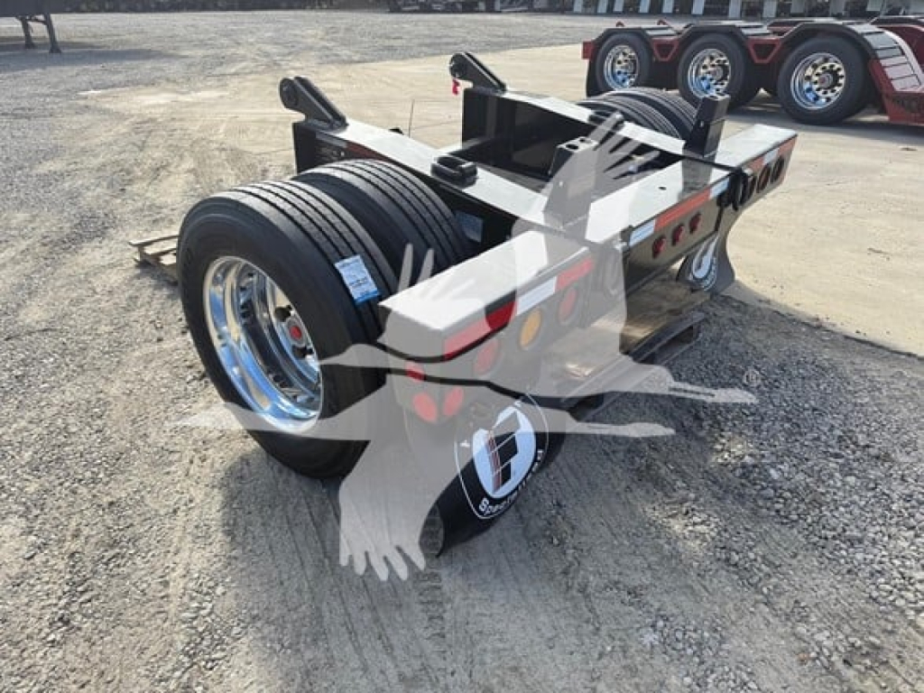 Fontaine flip axle trailer with dual rear tires and chrome wheels showing payload frame and hydraulic components.