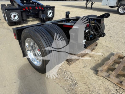 Fontaine flip-axle trailer hub and dual tires with hydraulic lines visible and mounting frame.
