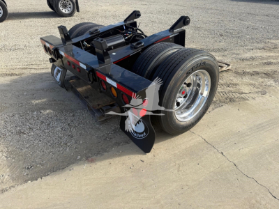 Fontaine flip axle trailer rear view showing dual tires and chassis, with loader and hydraulic components visible