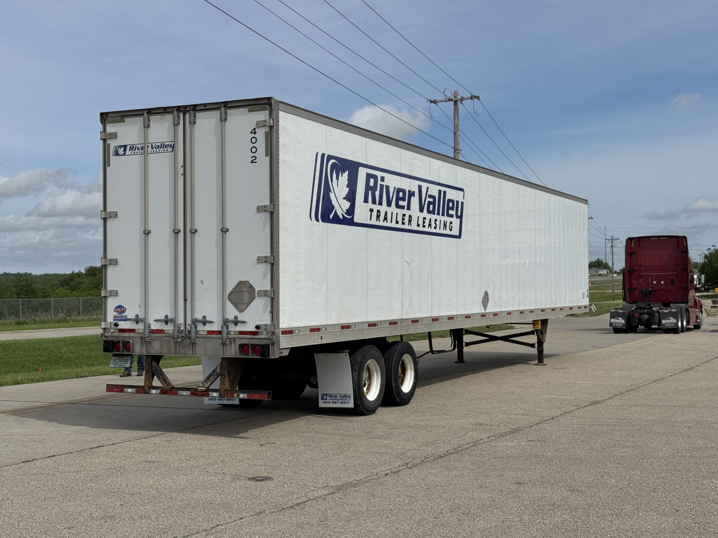 Trailer with River Valley Trailer Leasing logo on side showing 4002-1 and 4002 doors. Rear view includes two axles and utility trailer design.