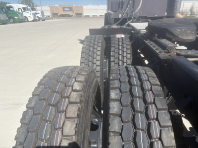 Kenworth T680 truck chassis showing dual rear axles and heavy-duty tires.