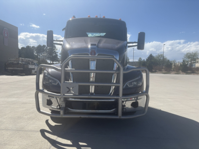 Kenworth T680 front view showing grille guard and bumper; chrome grille, headlights, hood, mirrors, and windshield; no visible text.