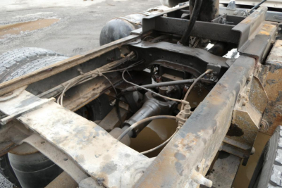 Truck chassis frame with exposed engine bay area on a Mack RD688S; visible hydraulic lines, frame rails, and components.