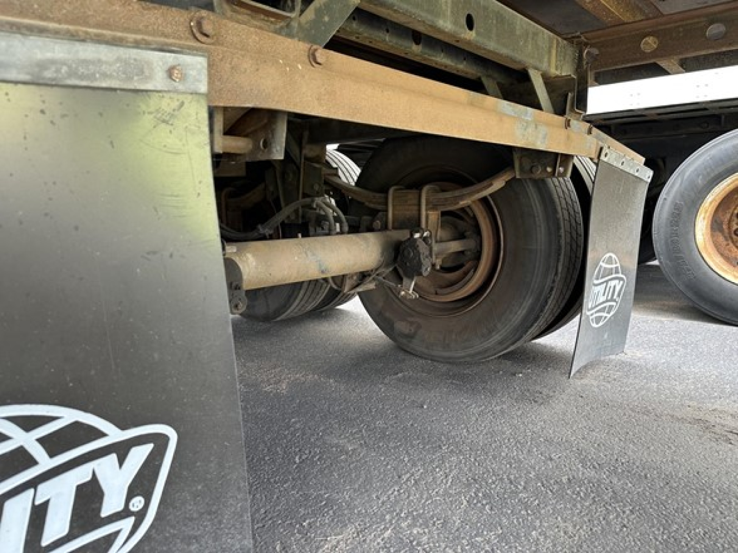 Trailer undercarriage showing rear wheel assembly and suspension components of a 2015 Utility Vector 8600 MT trailer.
