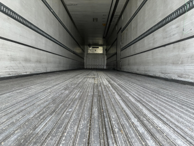 Trailer interior showing ribbed metal floor and side walls with rails, empty cargo area in a 2015 Utility 3000R reefer trailer.