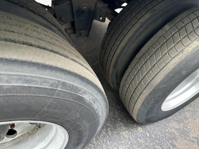 Trailer tire close-up view showing dual rear axles and tires on a 2015 Utility 3000R trailer.