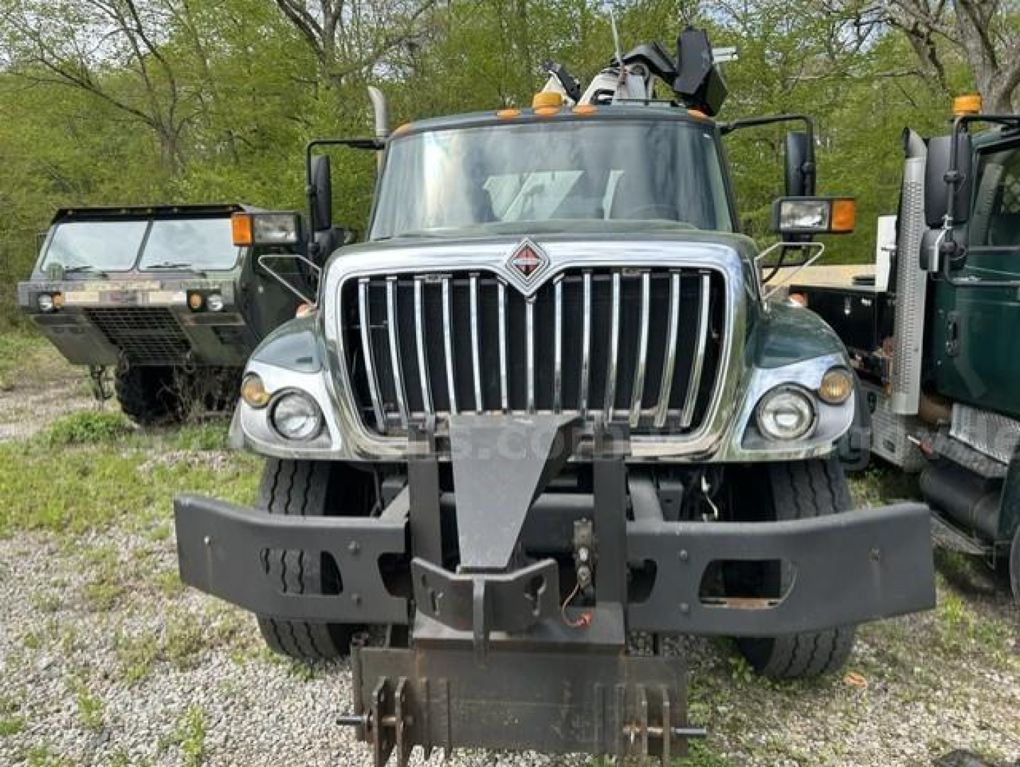 Front view of a 2012 International 7400 WorkStar dump truck showing a heavy front bumper and grille with International logo.