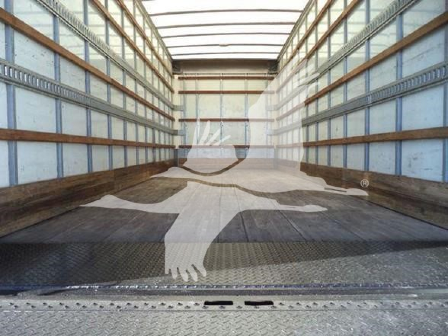 Interior of empty International Durastar 4300 box truck cargo area showing metal walls and floor.